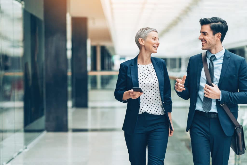 Two businesspersons walking together